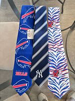 Front view of all three neckties showing designs and logos