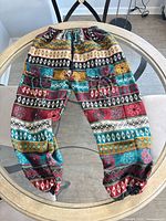 Full view of multicolor tribal harem pants laid flat