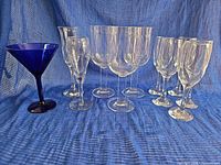 Group shot showing all ten pieces: blue martini, three flutes, two balloon goblets, four Austrian wine glasses