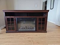 Front view closed doors showing entire console and fireplace insert