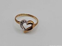 Front view showing open heart design and diamond accents