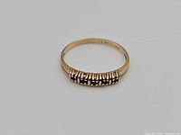 Front view of the 10K gold ring showing five inset stones