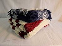 Both throws folded, showing colors and textures