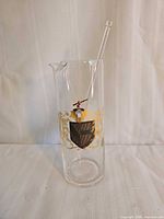 Pitcher with stir stick assembled, showing decoration and spout