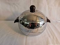 Lidded West Bend Penguin server front view showing knob and side handles