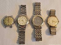 All four watches side by side showing overall condition and bracelets