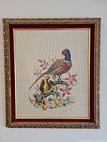Full view of framed needlepoint showing artwork and frame