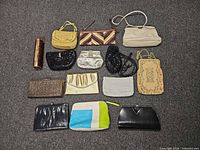 Group shot of all 14 purses and evening bags arranged on floor