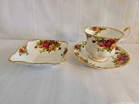 Teacup with saucer and square dish showing full lot