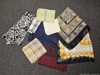 All nine scarves spread out to show variety of patterns and colors