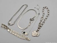 Five sterling silver bracelets laid out side-by-side