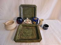 Group shot of all eight studio pottery items