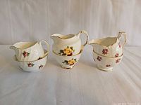 Three creamers stacked on matching sugar bowls showing all sets