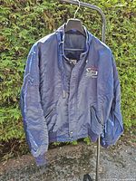 Full front view of navy Sony bomber jacket on hanger