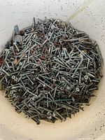 Close-up of screws inside bucket