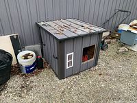 overall view of dog house beside wall