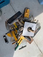Pile of assorted drywall, cement and tile tools