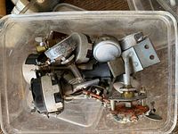 Plastic bin filled with assorted potentiometers and rotary controls