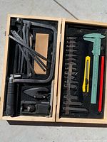 Full view of both halves of wooden case showing all tools