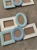 Two pastel blue/white quad-opening frames showing backing boards