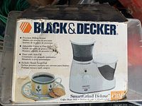 Front of boxed Black & Decker SmartGrind Deluxe coffee bean grinder