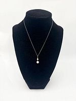 Full view of necklace on bust showing overall length and pendant drop