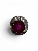 Front view of white gold pendant showing ruby center and diamond accent
