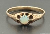 Ring top view showing opal and scalloped setting