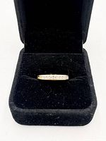 Ring displayed in open black presentation box, front view