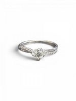 Front view of ring showing center diamond and accent stones