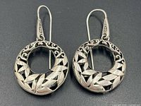 Front view of both earrings showing filigree and cut-out pattern, 925 stamp on ear wires