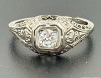 Front view showing central diamond and filigree mount