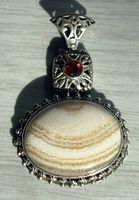 Front view showing banded agate, garnet, and silver bezel