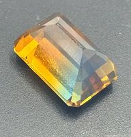 Oblique view of faceted bi-color gemstone showing yellow and blue zones