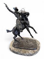 Full view of bronze cowboy and horse sculpture on marble base