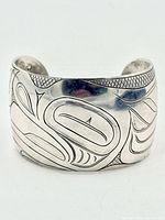 Front view showing full engraved frog motif on wide cuff