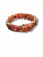 Top view of full bracelet showing raw amber segments and elastic construction