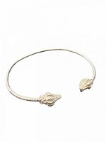 Full view of silver cuff showing conch shell ends