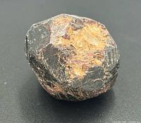Multiple angles of the single raw garnet crystal showing overall shape, color and natural surface
