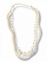 Full view of layered necklace showing paperclip chain and pearl strand