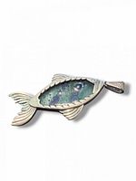 Front view of sterling silver fish pendant showing glass inlay and bezel