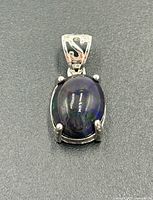 Front view of sterling silver pendant with black triplet opal