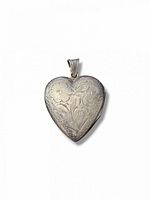 Front view of engraved sterling silver heart locket with bail