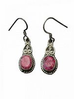 Front view of both sterling silver earrings with ruby cabochons