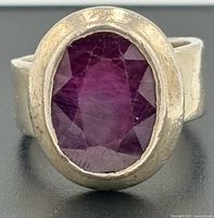 Front view of sterling silver ring showing oval ruby