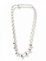 Full view of articulated sterling silver necklace showing overall design and length