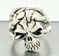 front view of sterling silver skull ring showing cracked skull detail
