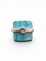 Front view of ring showing rectangular turquoise and silver bar with clear stone