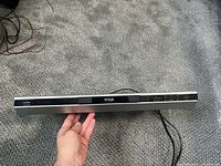Front view of RCA slim DVD player showing brand badge, disc tray and overall slim design