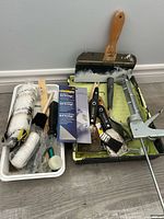 All painting tools and accessories laid out on floor